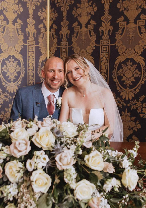 Bride and groom with wedding flowers by Elimay's Flowers, Flintshire