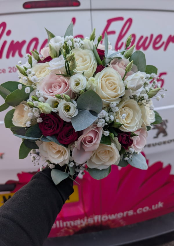 Bride holding a bespoke Elimay's Flowers wedding bouquet